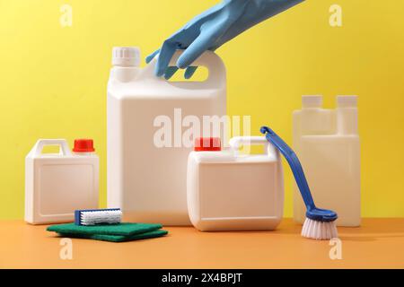 Minimal scene for advertising cleansing product with mockup bottle blank label for design. Front view of different size of white canisters with brush, Stock Photo