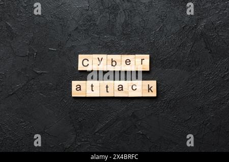 Cyber attack word written on wood block. Cyber attack text on cement table for your desing, concept. Stock Photo