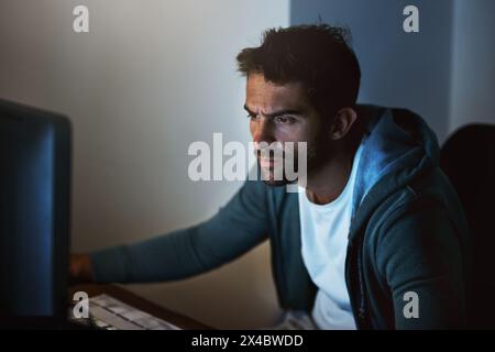 Computer, man or hacker thinking at night of cyber security, programming or digital network safety. Male person, technology or pc in home planning Stock Photo
