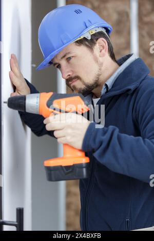 male builder using cordless drill Stock Photo