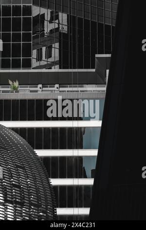 Abstract and urban style of metal and glass buildings reflecting each other with different geometric shapes looking like a black and white mosaic with Stock Photo