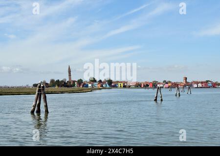 Burano, Italy - View of the colorful houses, the historic water tower and the church Chiesa Parrocchiale di San Martino Vescovo with the leaning steep Stock Photo