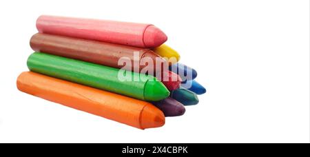 Crayon background. Crayons isolated in white backgrond. Pile of crayons over white background. Yellow, blue, and red crayon isolated on white background. Crayon arranged one over the other. Crayon. Stock Photo