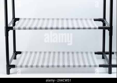 Empty shelf  in shoe rack isolated on white studio background Stock Photo