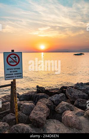 Bardolino, Lake Garda, Italy - 11 September 2023 No diving sign seen near walkway at Cisano Stock Photo