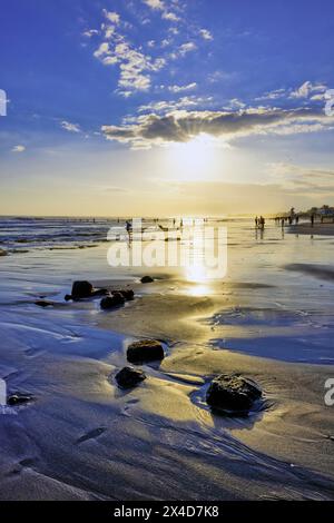 The warm yellows and the cool blues as the sun begins to set on Bali, Indonesia Stock Photo