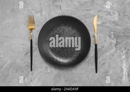 Elegant setting with shiny cutlery on grey table, top view Stock Photo