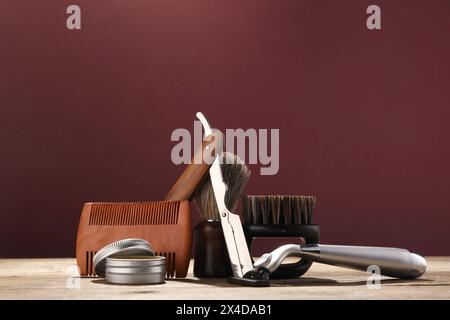 Moustache and beard styling tools on wooden table Stock Photo