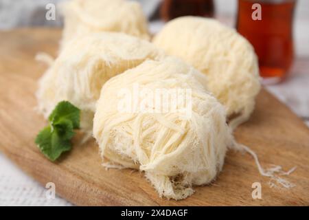 Eastern sweets. Tasty Iranian pashmak on white wooden table, closeup Stock Photo