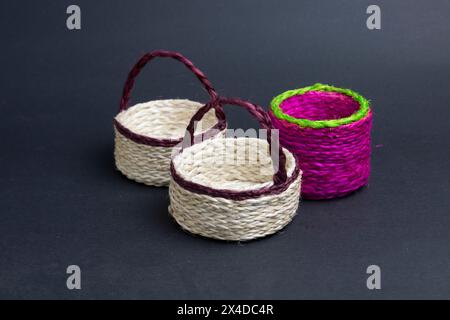three empty jute bucket on black background. Stock Photo