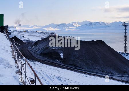 Storage of the coal from the mine. Russian coal mining town Barentsburg at fjord Gronfjorden. The coal mine is still in operation. Arctic Region, Scan Stock Photo