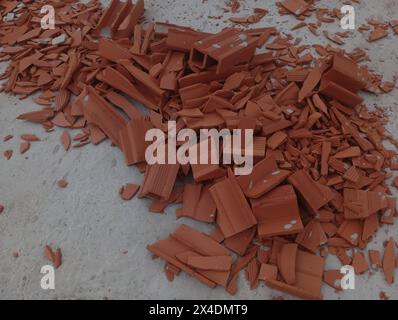 Red brick waste on the floor. Construction waste. Stock Photo