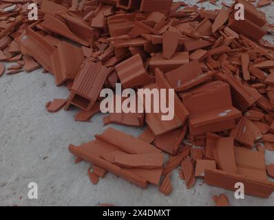 Red brick waste on the floor. Construction waste. Stock Photo