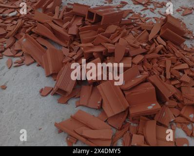 Red brick waste on the floor. Construction waste. Stock Photo