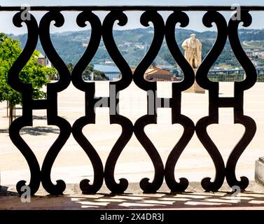 Statue of King Joao III in the courtyard as seen through the hallway of the Faculty of Law . Stock Photo