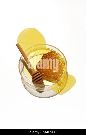 Abstract cosmetic laboratory.. Fresh Honey and Honeycomb in Glass Petri.. Stock Photo