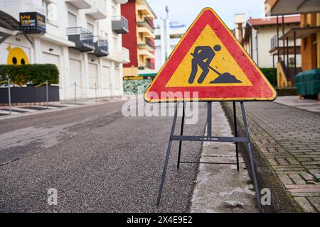 Lido di Jesolo, Italy - 2 May 2024: Warning sign on a road in Italy, construction site *** Warnschild an einer Straße in Italien, Baustelle Stock Photo