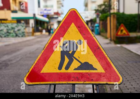 Lido di Jesolo, Italy - 2 May 2024: Warning sign on a road in Italy, construction site *** Warnschild an einer Straße in Italien, Baustelle Stock Photo