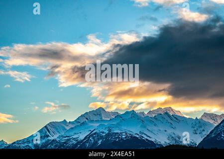 USA, Alaska, Chilkat River Valley. Mountain landscape and clouds at sunset. Stock Photo