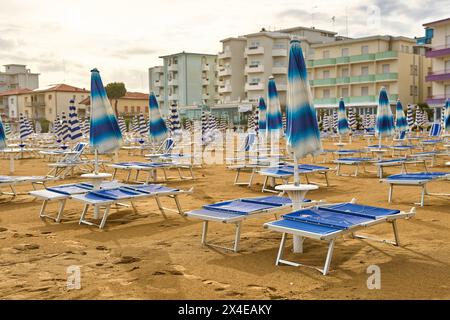 Lido di Jesolo, Italy - 2 May 2024: Closed umbrellas on the beach of Lido di Jesolo in Italy *** Geschlossene Sonnenschirme am Strand von Lido di Jesolo in Italien Stock Photo