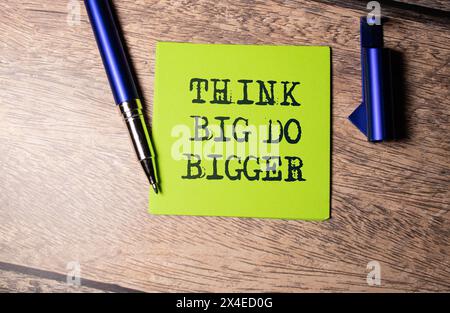 Think Big, Do Bigger Motivation quote written on a note paper Stock Photo