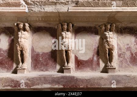 Pompeii thermal baths, or public baths interior; statues on the wall, of the baths, dating from 1st century AD; Pompeii Forum baths; Pompeii Italy Stock Photo