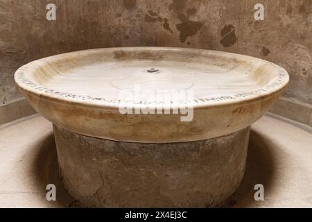 Pompeii thermal baths, or public baths interior; cold water fountain or basin in the hot room, Forum baths, Pompeii ruins, Italy. Roman Civilisation Stock Photo