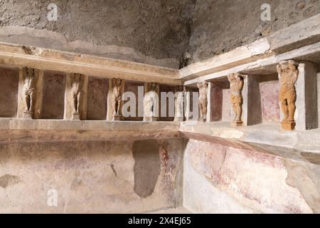 Pompeii thermal baths, or public baths interior; statues on the wall, of the baths, dating from 1st century AD; Pompeii Forum baths; Pompeii Italy Stock Photo