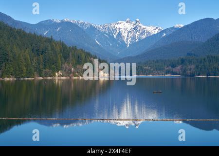 Capilano Lake Lions Peaks Reflection North Vancouver. The view of the Lions high over the Capilano Lake Reservoir in Capilano River Regional Park, Nor Stock Photo