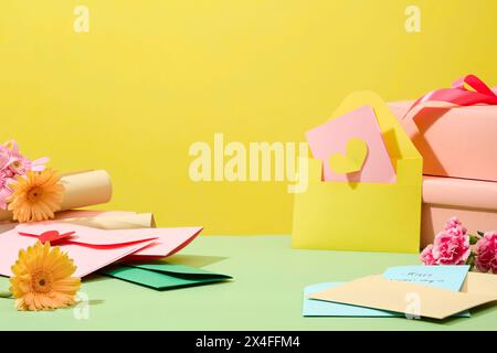 Colorful background for design or advertising on women's day. Cute paper cards, fresh gerbera and carnation flower decorated. Blank space to place you Stock Photo