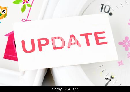 Business concept. UPDATE Word text on the business card on the background of the clock Stock Photo
