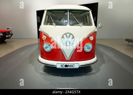classic vintage red and white Volkswagen bus, automotive pop culture nostalgia 1960s, display Iconic show Volkswagen Group Forum in Berlin, Germany - Stock Photo