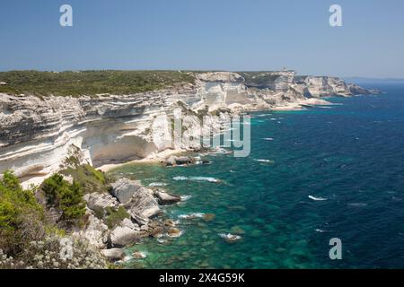 Bonifacio, Corse-du-Sud, Corsica, France. View along rugged limestone cliffs to Capo Pertusato and the distant Sardinian coast. Stock Photo