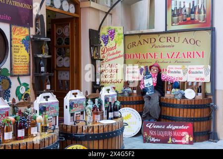 Saint-Florent, Haute-Corse, Corsica, France. Attractive display of Patrimonio wines outside town centre wine shop. Stock Photo