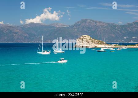 Saint-Florent, Haute-Corse, Corsica, France. View across clear turquoise water to the Cap Corse peninsula from coastline near the Plage du Loto. Stock Photo