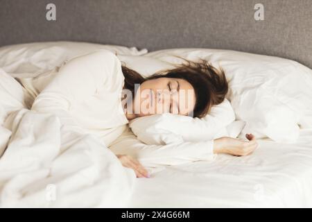 Portrait of young woman sleeping in bed Stock Photo