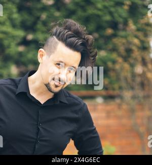 Portrait of smiling man in black shirt Stock Photo