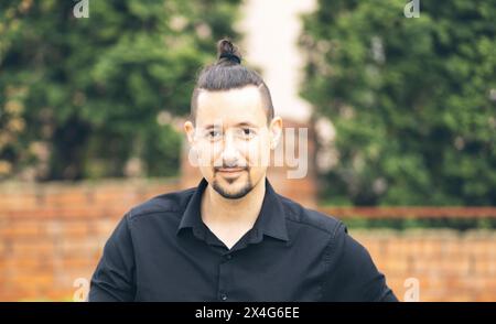Portrait of smiling man in black shirt Stock Photo