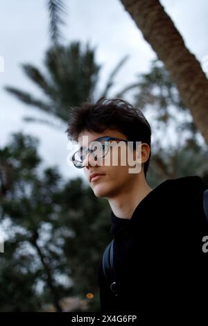 Pensive young person in glasses Stock Photo