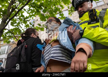London / UK. 02 May 2024.  Protestors block High street in Peckham outside Great Western Hotel to prevent the removal of refugees to the Bibby Stockholm barge. Alamy Live News / Aubrey Fagon Stock Photo