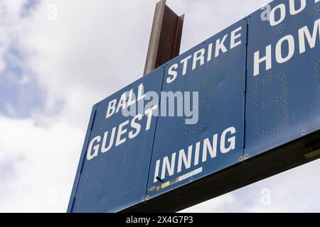 Baseball scoreboard under cloudy sky Stock Photo