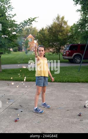 Girl in yellow with sparkler Stock Photo