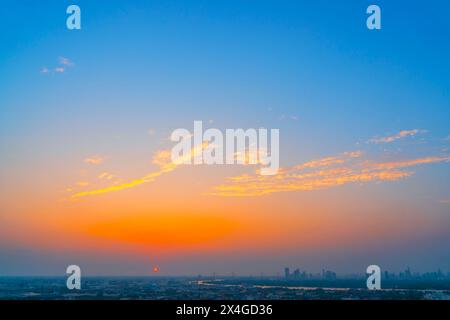 Yellow blue orange gradient with clouds over the city. Stock Photo