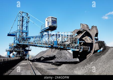 Bucket wheel stacker reclaimer in maritime bulk terminal of coal harbor. Stock Photo