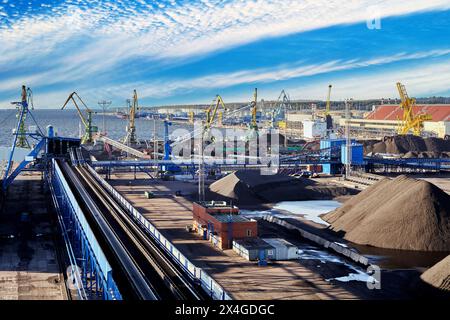 Port stacking and loading fixed belt conveyor system at dry bulk cargo terminal, coal harbor. Stock Photo