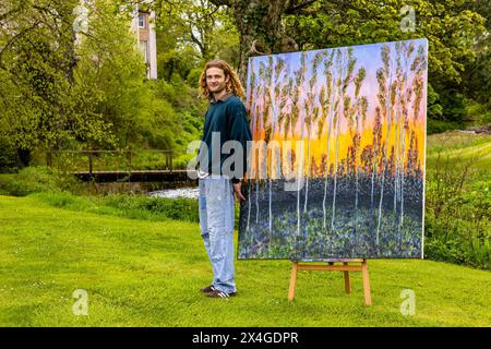 Haddington, United Kingdom. 03 May, 2024 Pictured: Artist Joe Grieve with his work End of the Road in the grounds of Colstoun House. Colstoun Arts is a new venture in Colstoun House in Haddington, outside Edinburgh. It is partly about diversification and new ways to sustain a country house, and partly about starting the journey to their vision – to become a national museum for landscape art. The first exhibition at the venue, The Other Side, features large-scale works by Landscape Painter, Joe Grieve. Credit: Rich Dyson/Alamy Live News Stock Photo