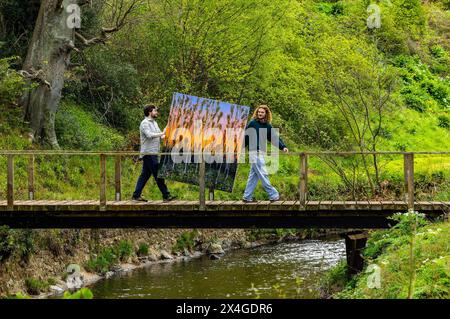 Haddington, United Kingdom. 03 May, 2024 Pictured: McLean Sinclair-Parry, Director of Colstoun Arts and Artist, Joe Grieve with his work The End of The Road in the grounds of Colstoun House. Colstoun Arts is a new venture in Colstoun House in Haddington, outside Edinburgh. It is partly about diversification and new ways to sustain a country house, and partly about starting the journey to their vision – to become a national museum for landscape art. The first exhibition at the venue, The Other Side, features large-scale works by Landscape Painter, Joe Grieve. Credit: Rich Dyson/Alamy Live News Stock Photo