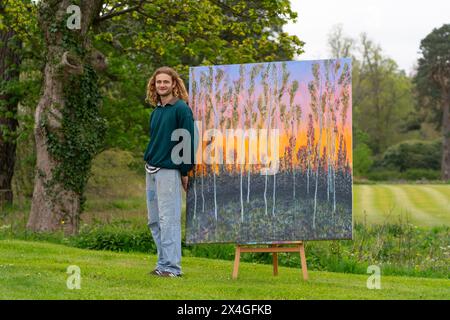 Haddington, Scotland, UK. 3rd  May 2024. Landscape artist Joe Grieve displays his paintings at Colstoun House near Haddington. His exhibition marks the opening of the first exhibition of Colstoun Arts which a new venture, partly about diversification and new ways to sustain a country house, and partly about starting the journey to their vision – to become a national museum for landscape art. Pic Artist Joe Grieve with painting End of the Road.    Iain Masterton/Alamy Live News Stock Photo