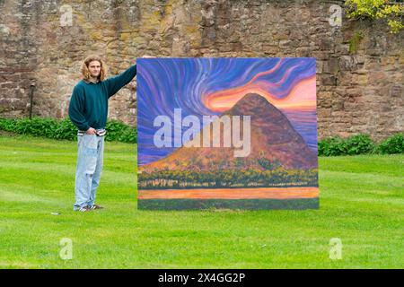 Haddington, Scotland, UK. 3rd  May 2024. Landscape artist Joe Grieve displays his paintings at Colstoun House near Haddington. His exhibition marks the opening of the first exhibition of Colstoun Arts which a new venture, partly about diversification and new ways to sustain a country house, and partly about starting the journey to their vision – to become a national museum for landscape art. Pic; artist Joe Grieve beside painting The Law .  Iain Masterton/Alamy Live News Stock Photo