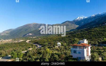 Snow capped peak of Mount Cika and mountain road over Llogara Pass, Palase, near Dhermi, Albania,  Europe Stock Photo